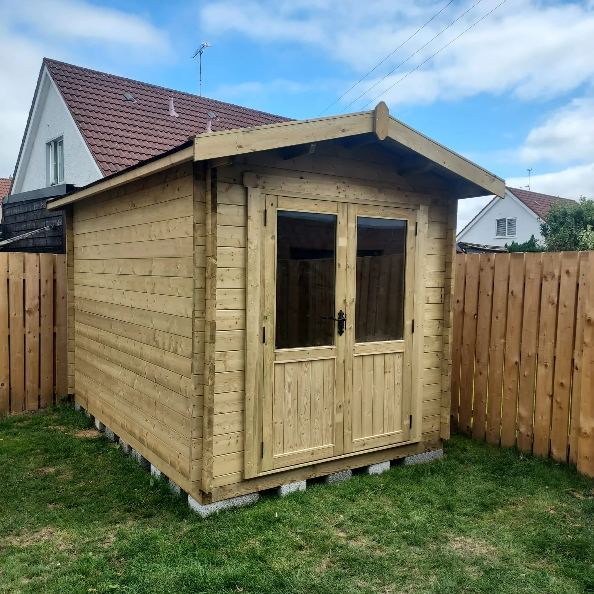 Handcrafted timber garden shed with glazed double doors