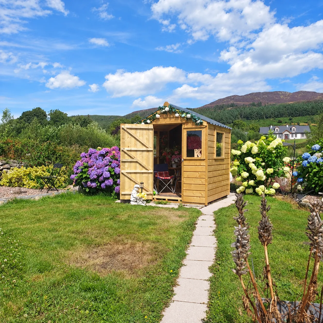 Handcrafted timber garden shed in a landscaped Irish garden